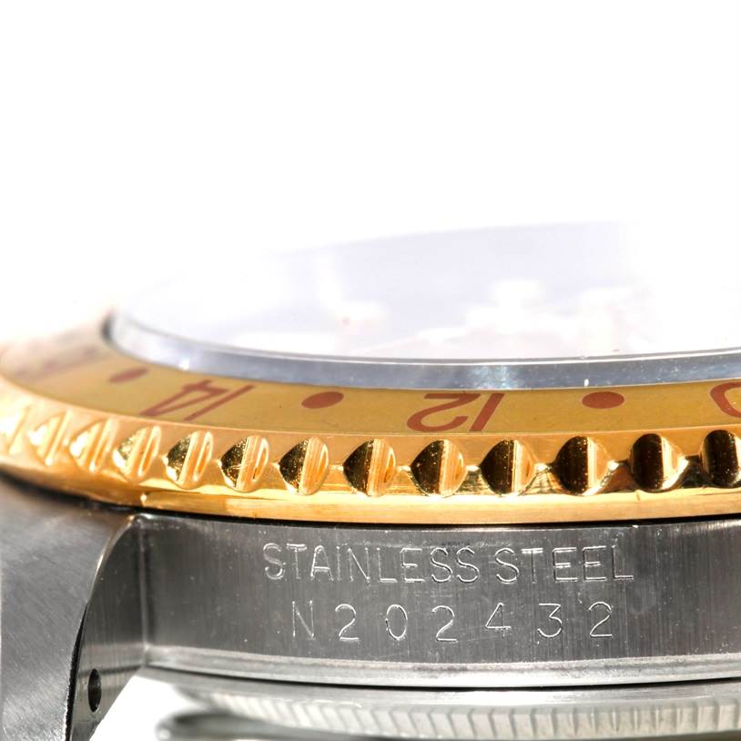 This close-up angle shows the side of the Rolex GMT-Master 16713 Men's Stainless Steel Brown Dial 16713 Men's Stainless Steel Brown Dial watch, highlighting the bezel, crystal, and portion of the case with engravings.