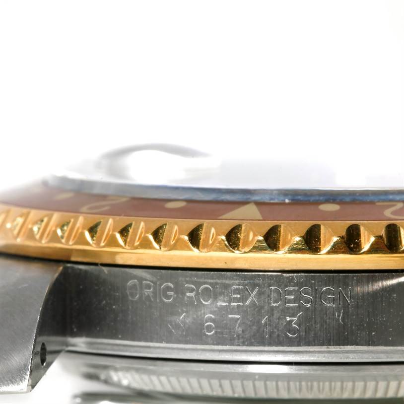 This image shows a side view of the bezel and part of the case of a Rolex GMT-Master 16713 Men's Stainless Steel Brown Dial 16713 Men's Stainless Steel Brown Dial model watch.