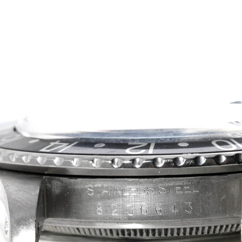 The image shows a close-up angle of the Rolex GMT-Master 16750 Men's Stainless Steel Black Dial 16750 Men's Stainless Steel Black Dial watch, focusing on the side of the bezel and the serial number on the case.
