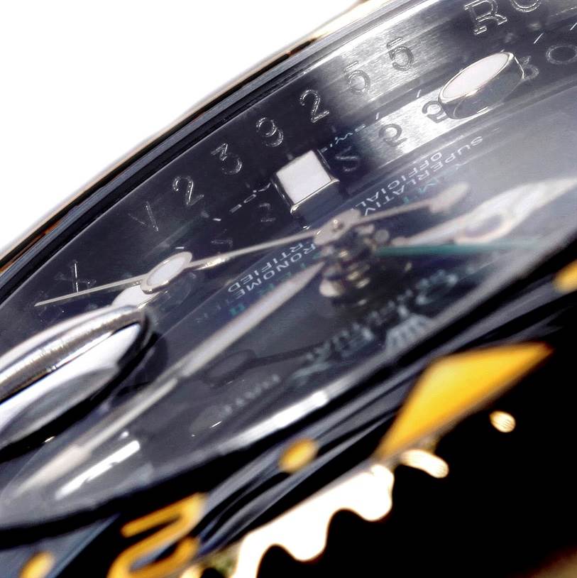 This close-up angle of the Rolex GMT-Master 116713 Men's Stainless Steel Black Dial 116713 Men's Stainless Steel Black Dial watch showcases its dial and part of the bezel.