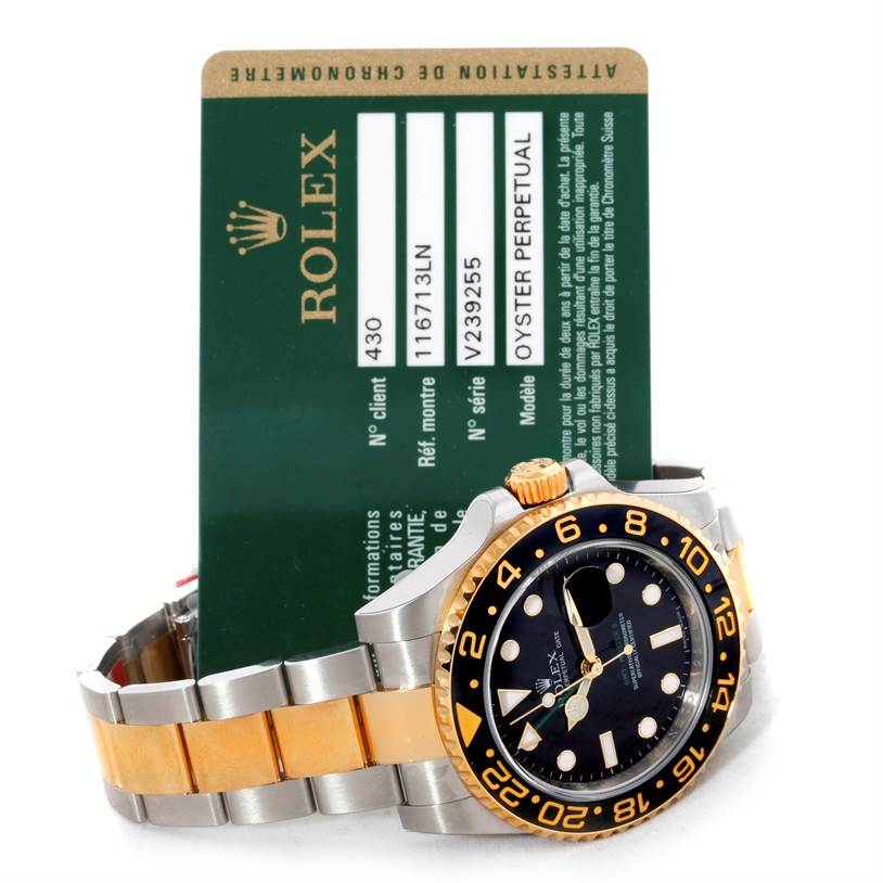 The image shows a Rolex GMT-Master 116713 Men's Stainless Steel Black Dial 116713 Men's Stainless Steel Black Dial watch at an angle, emphasizing its face, bezel, crown, and part of the bracelet, alongside its certification card.
