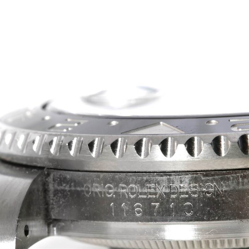 This image shows a close-up side view of the bezel and case of the Rolex GMT-Master 116710 Men
s Stainless Steel Black Dial 116710 Men
s Stainless Steel Black Dial, highlighting the "ORIG. ROLEX DESIGN" engraving.