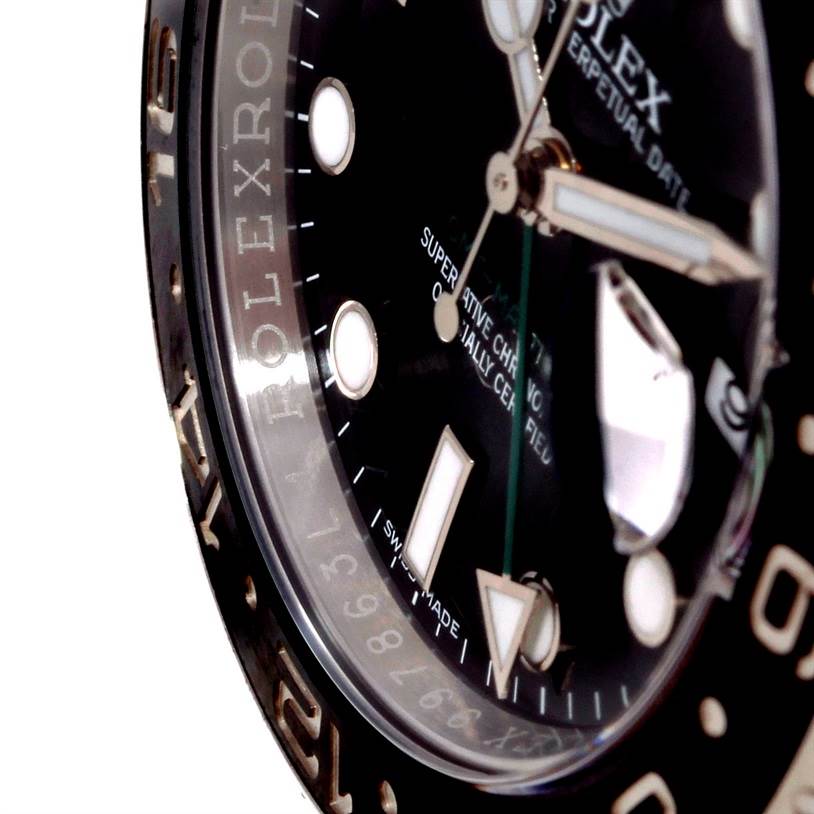 The image shows a close-up side view of the dial and hands of a Rolex GMT-Master 116710 Men
s Stainless Steel Black Dial 116710 Men
s Stainless Steel Black Dial watch, including parts of the bezel and markers.