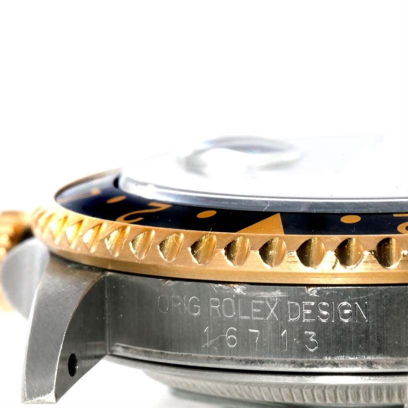 This image shows a close-up side view of the bezel, case, and reference number of a Rolex GMT-Master 16713 Men
s Stainless Steel Black Dial 16713 Men
s Stainless Steel Black Dial watch.