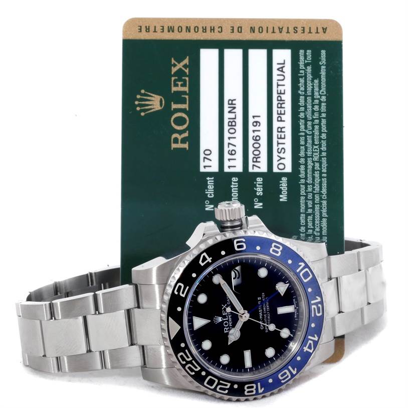 The image shows a Rolex GMT-Master 116710 Men's Stainless Steel Black Dial 116710 Men's Stainless Steel Black Dial watch, lying flat with a green Rolex certification card standing behind it.