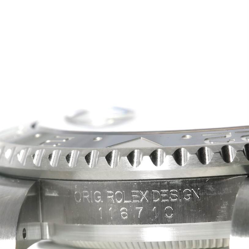 The image shows a close-up angled view of the Rolex GMT-Master 116710 Men's Stainless Steel Black Dial 116710 Men's Stainless Steel Black Dial's bezel and case with the model reference number engraved.