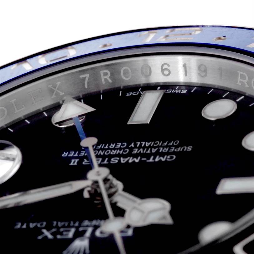 The image shows a close-up angle of the dial and bezel of the Rolex GMT-Master 116710 Men's Stainless Steel Black Dial 116710 Men's Stainless Steel Black Dial II watch, highlighting the model engraving and the hands.