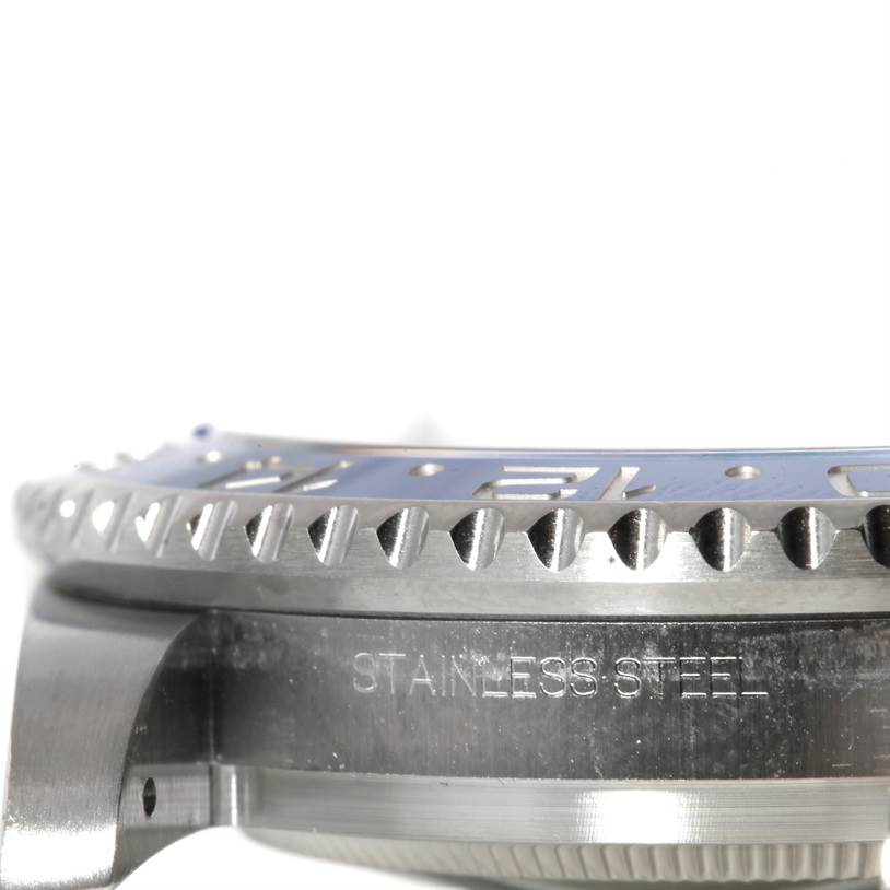 This image shows a close-up of the bezel and part of the stainless steel case of a Rolex GMT-Master 116710 Men's Stainless Steel Black Dial 116710 Men's Stainless Steel Black Dial watch.