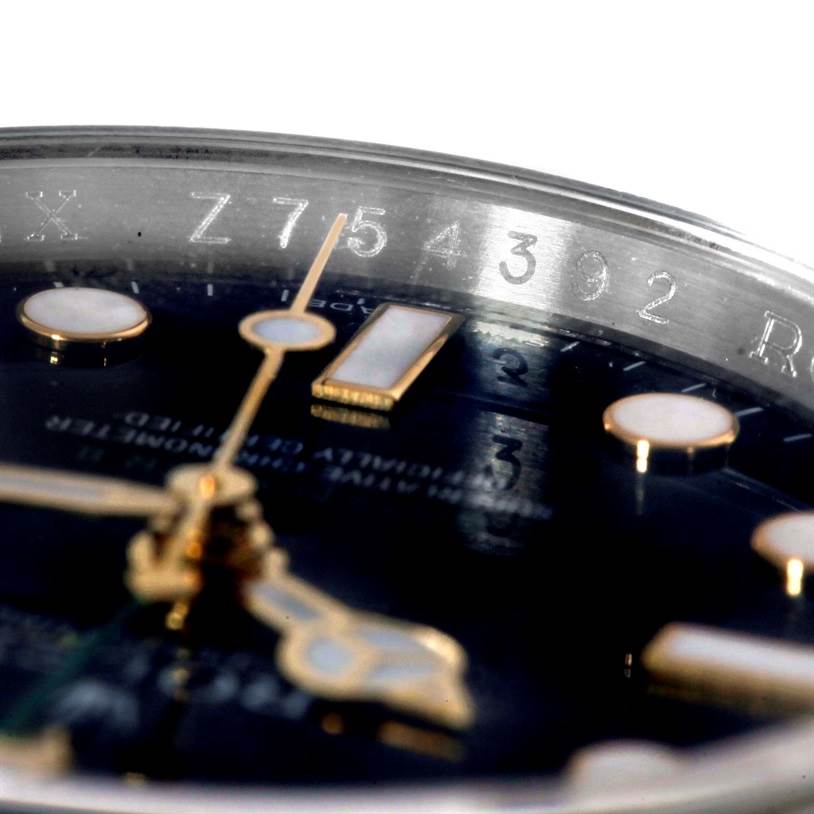 The image shows a close-up of the dial and serial number engraving on the bezel of a Rolex GMT-Master 116713 Men's Stainless Steel Black Dial 116713 Men's Stainless Steel Black Dial watch.