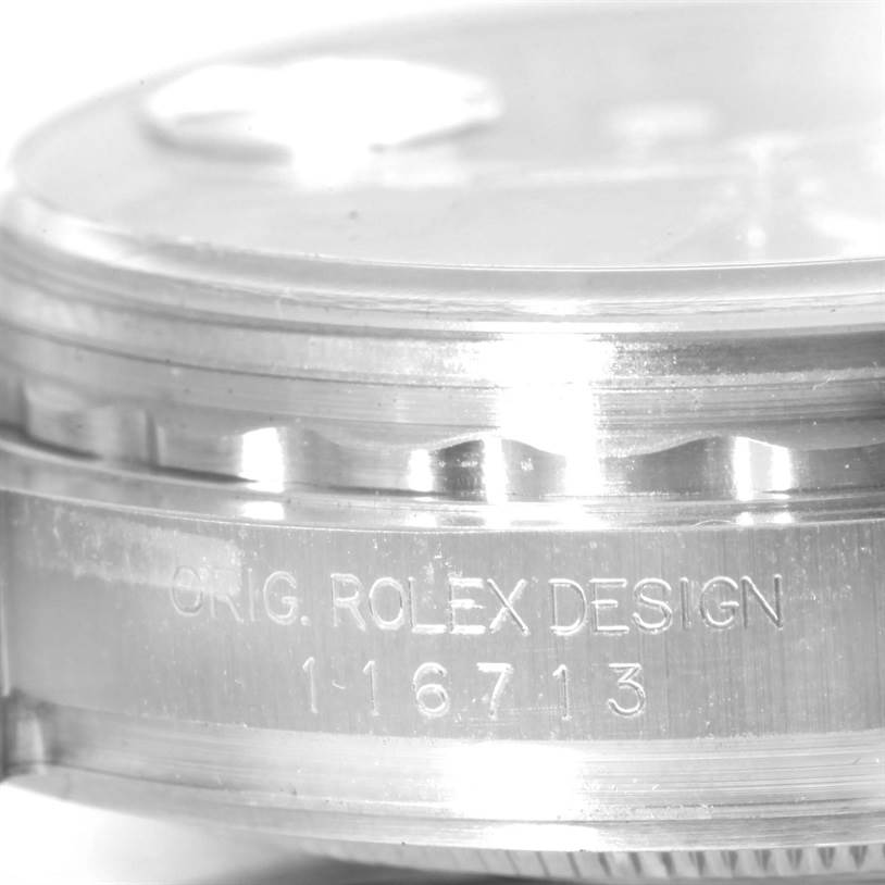 Close-up of the casing side of a Rolex GMT-Master 116713 Men's Stainless Steel Black Dial 116713 Men's Stainless Steel Black Dial, displaying "ORIG. ROLEX DESIGN 16713" engraving.