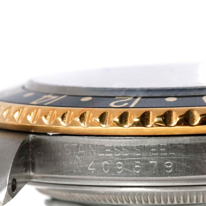 The image shows a close-up side view of the Rolex GMT-Master 16713 Men's Stainless Steel Black Dial 16713 Men's Stainless Steel Black Dial, focusing on the bezel and part of the watch case.