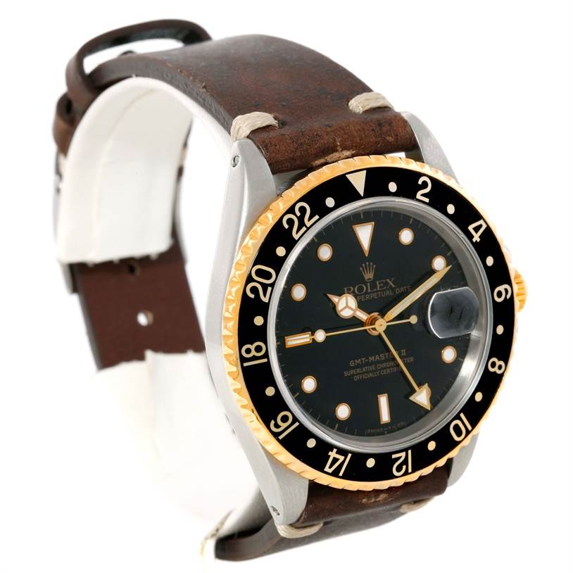 The Rolex GMT-Master 16713 Men's Stainless Steel Black Dial 16713 Men's Stainless Steel Black Dial watch is shown at a front angle, highlighting its bezel, dial, and leather strap.