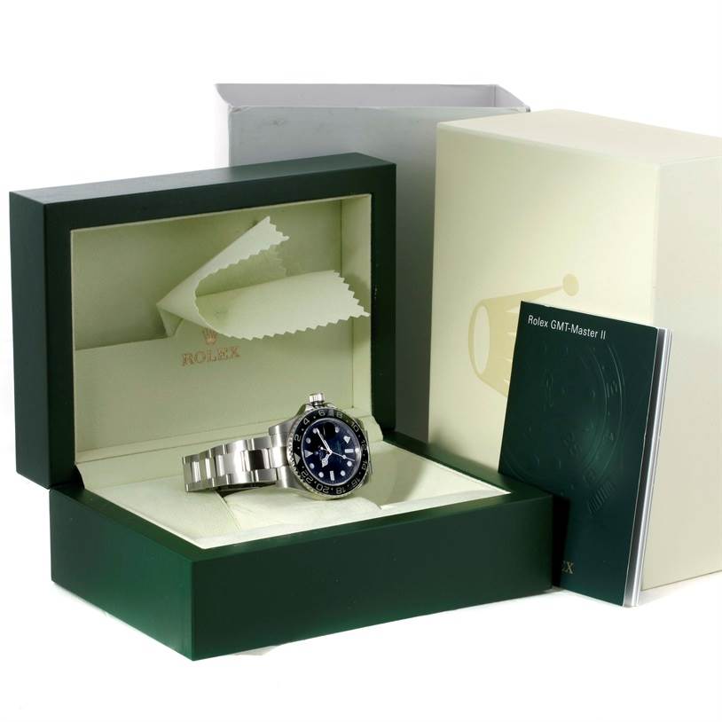 This image shows a Rolex GMT-Master 116710 Men's Stainless Steel Black Dial 116710 Men's Stainless Steel Black Dial watch placed in its open box, along with its accompanying booklets.
