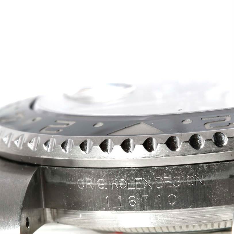 This image shows a close-up side view of the bezel and case edge of a Rolex GMT-Master 116710 Men's Stainless Steel Black Dial 116710 Men's Stainless Steel Black Dial model, showcasing the model number and design engraving.