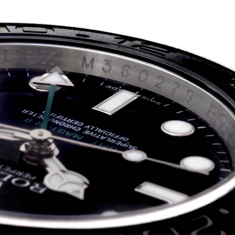This image shows a close-up angle of the dial and inner bezel of a Rolex GMT-Master 116710 Men's Stainless Steel Black Dial 116710 Men's Stainless Steel Black Dial watch, featuring the model's serial number.