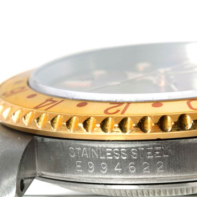 The image shows a close-up, side angle view of the bezel and the case of a Rolex GMT-Master 16713 Men's Stainless Steel Brown Dial 16713 Men's Stainless Steel Brown Dial watch.