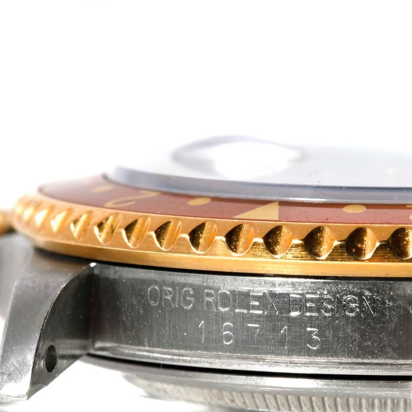 The image shows a close-up side view of the bezel and case side of a Rolex GMT-Master 16713 Men's Stainless Steel Brown Dial 16713 Men's Stainless Steel Brown Dial watch, revealing its model number 16713.
