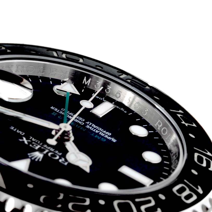 This image shows a close-up angled view of the dial, bezel, and inner rim of the Rolex GMT-Master 116710 Men's Stainless Steel Black Dial 116710 Men's Stainless Steel Black Dial watch.