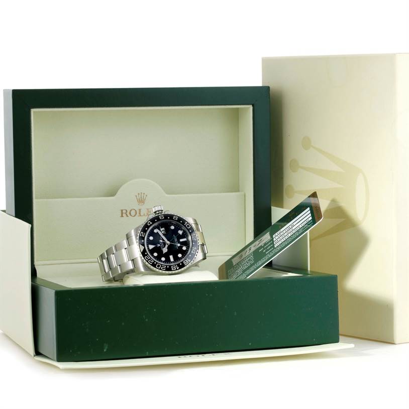 The Rolex GMT-Master 116710 Men's Stainless Steel Black Dial 116710 Men's Stainless Steel Black Dial watch is displayed front-facing in an open green and cream box, showcasing the dial, case, and bracelet.