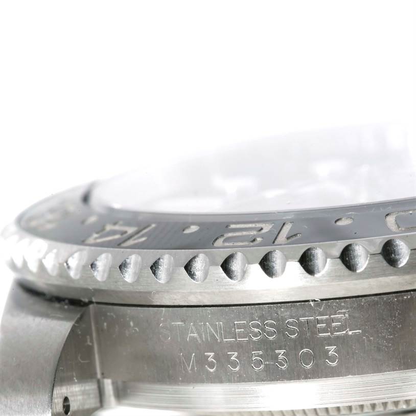 This close-up image of a Rolex GMT-Master 116710 Men's Stainless Steel Black Dial 116710 Men's Stainless Steel Black Dial watch shows the stainless steel case, bezel with engraved numerals, and part of the crystal.