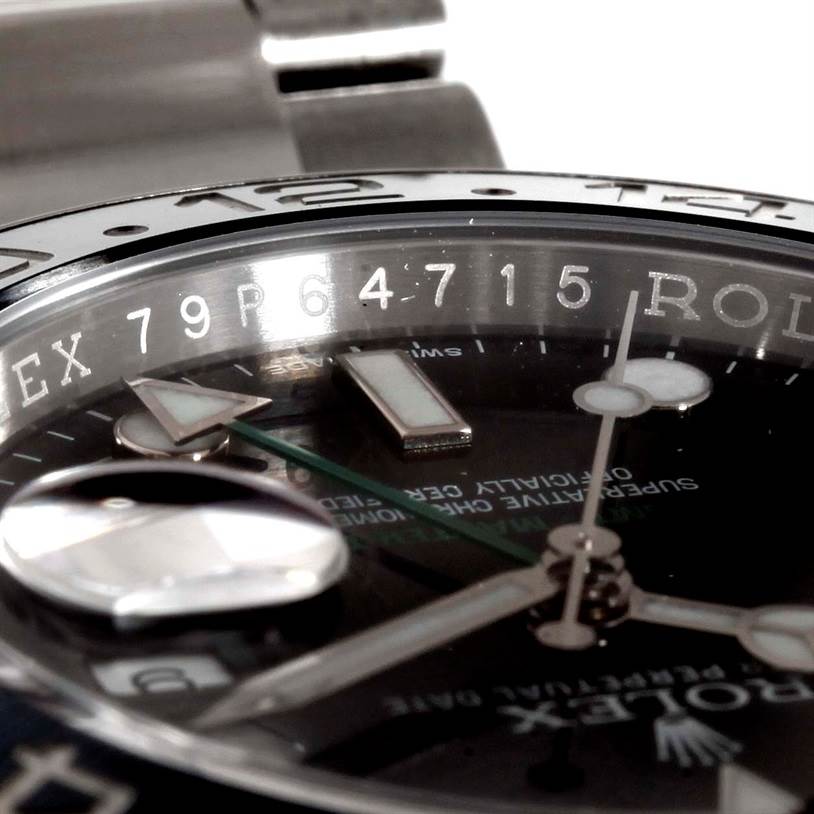 This close-up image of the Rolex GMT-Master 116710 Men's Stainless Steel Black Dial 116710 Men's Stainless Steel Black Dial watch shows the bezel, partial dial, hour markers, and hands.