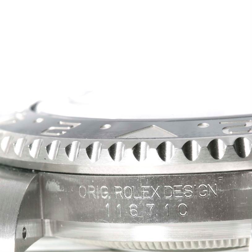This close-up image shows the side of the bezel and case of a Rolex GMT-Master 116710 Men's Stainless Steel Black Dial 116710 Men's Stainless Steel Black Dial, highlighting the model number and "Orig Rolex Design" engraving.