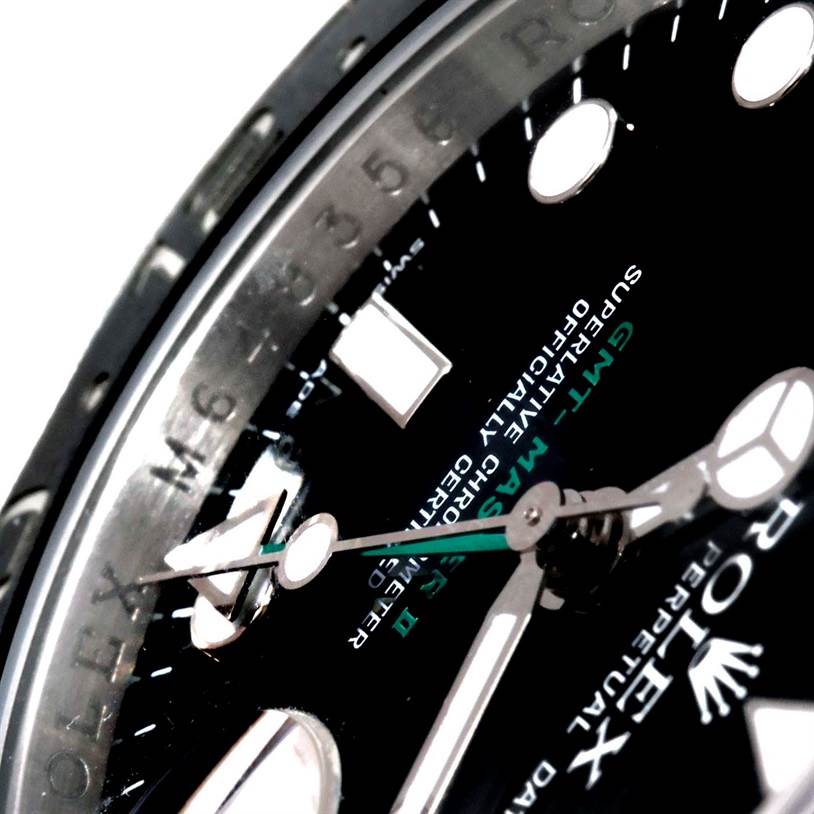 Close-up view of the Rolex GMT-Master 116710 Men's Stainless Steel Black Dial 116710 Men's Stainless Steel Black Dial watch face, showing the hands, markers, and part of the bezel from an oblique angle.
