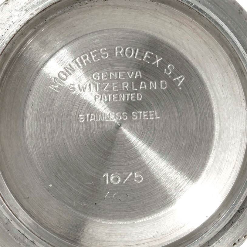 This image shows the inner case back of a Rolex GMT-Master 1675 Men's Stainless Steel Black Dial 1675 Men's Stainless Steel Black Dial watch, displaying inscriptions such as "Stainless Steel" and "1675".