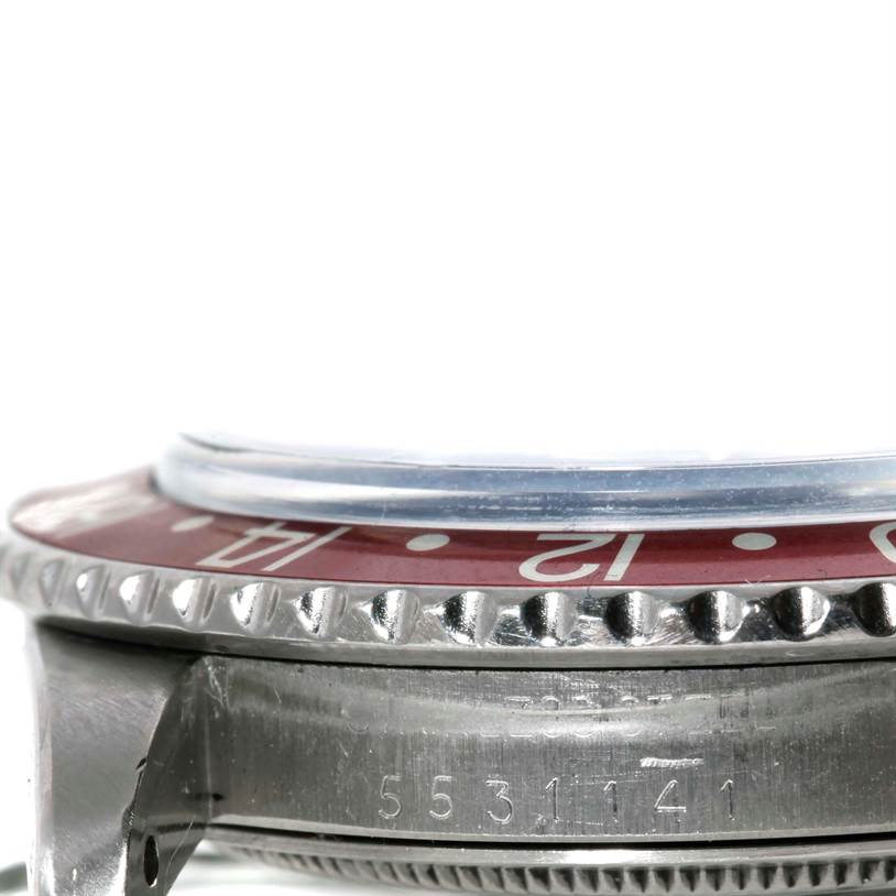 This image shows a side view of the bezel and case of a Rolex GMT-Master 1675 Men's Stainless Steel Black Dial 1675 Men's Stainless Steel Black Dial watch, highlighting part of the serial number.