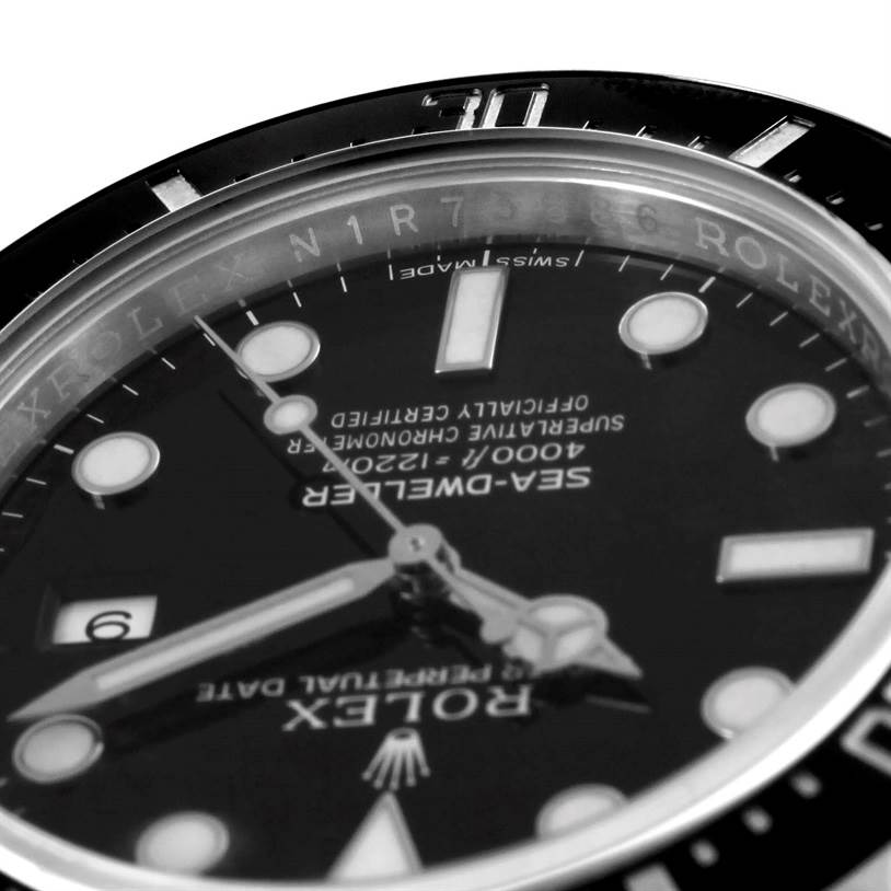 The image shows a close-up angle of the dial and bezel of the Rolex Sea-Dweller 116600 Men
s Stainless Steel Black Dial 116600 Men
s Stainless Steel Black Dial watch.