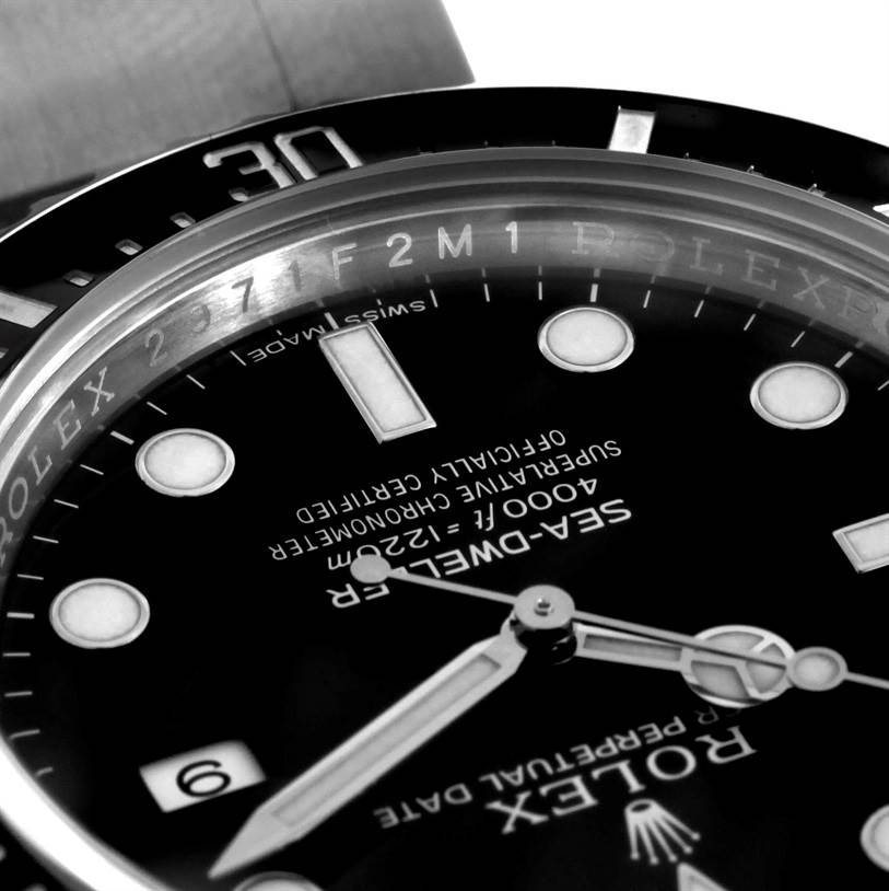The image shows a close-up view of the dial and bezel of a Rolex Sea-Dweller 116600 Men
s Stainless Steel Black Dial 116600 Men
s Stainless Steel Black Dial watch, highlighting the hands, markers, and text details.
