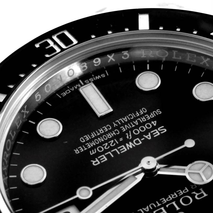 The image shows a close-up of the dial and bezel of a Rolex Sea-Dweller 116600 Men's Stainless Steel Black Dial 116600 Men's Stainless Steel Black Dial watch, highlighting the markers and text.