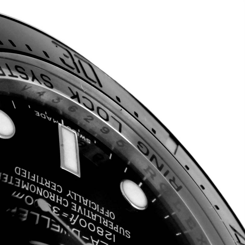 The image shows a close-up of the bezel and partial dial of the Rolex Sea-Dweller 116660 Men's Stainless Steel Black Dial 116660 Men's Stainless Steel Black Dial watch.