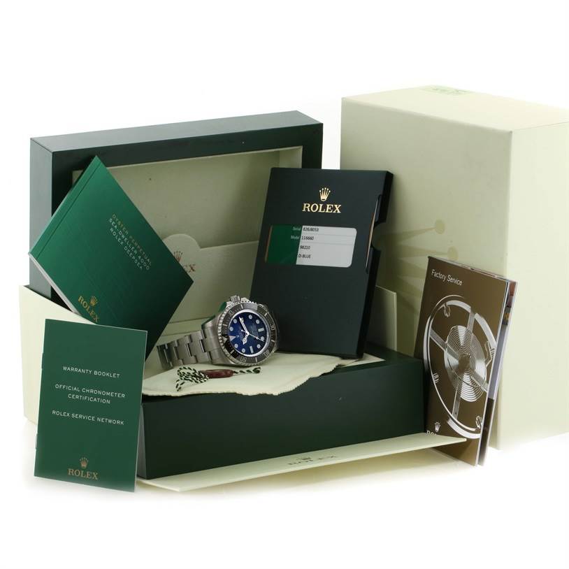 The Rolex Sea-Dweller 116660 Men's Stainless Steel Blue Dial 116660 Men's Stainless Steel Blue Dial watch is displayed in its packaging with accompanying booklets and certification documents.