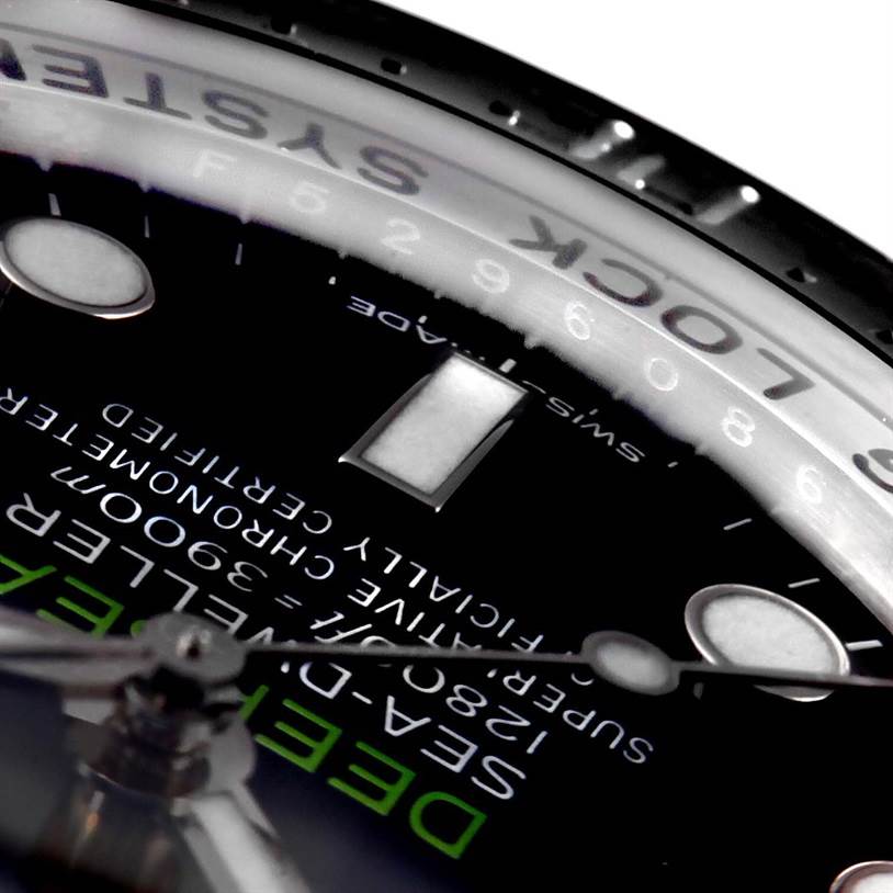 The image shows a close-up angled view of the dial and part of the bezel of the Rolex Sea-Dweller 116660 Men
s Stainless Steel Blue Dial 116660 Men
s Stainless Steel Blue Dial watch.