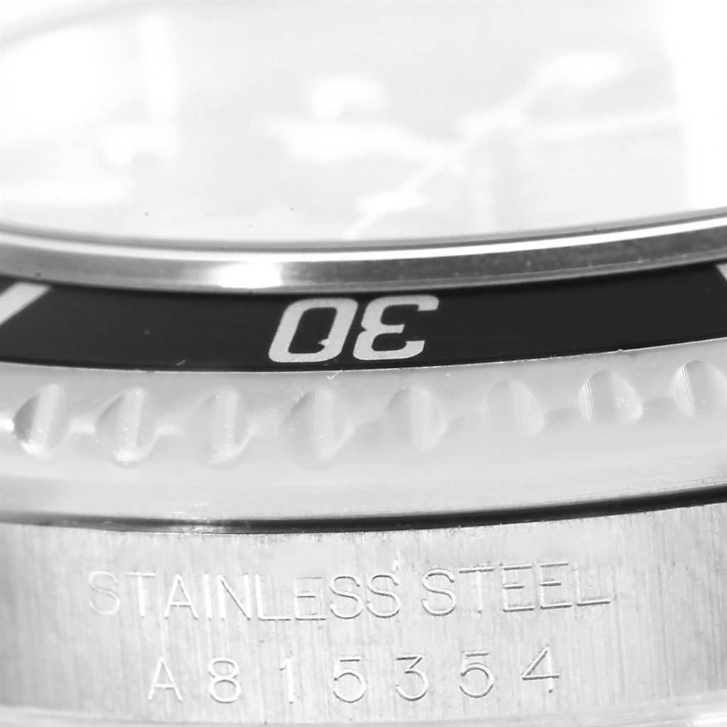 The image shows a close-up of the bezel and part of the case of a Rolex Sea-Dweller 16600 Men
s Stainless Steel Black Dial 16600 Men
s Stainless Steel Black Dial watch.