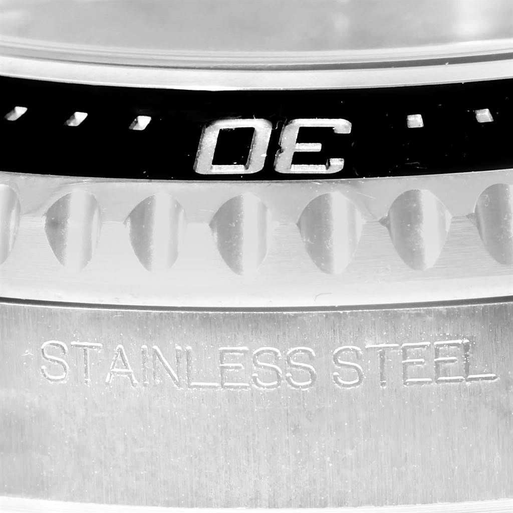 This close-up image shows part of the bezel and case, with "STAINLESS STEEL" engraved, of a Rolex Sea-Dweller 116600 Men's Stainless Steel Black Dial 116600 Men's Stainless Steel Black Dial watch.