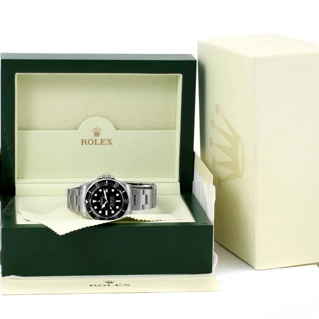 The Rolex Sea-Dweller 116600 Men's Stainless Steel Black Dial 116600 Men's Stainless Steel Black Dial watch is shown from the front, displayed in its open box with the outer box nearby.