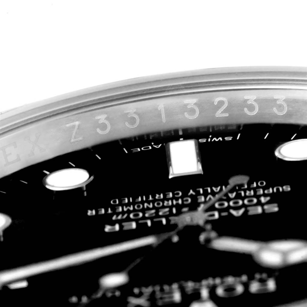 The image shows a close-up angle of the Rolex Sea-Dweller 116600 Men's Stainless Steel Black Dial 116600 Men's Stainless Steel Black Dial watch, focusing on the rehaut with engraved serial number and part of the dial.