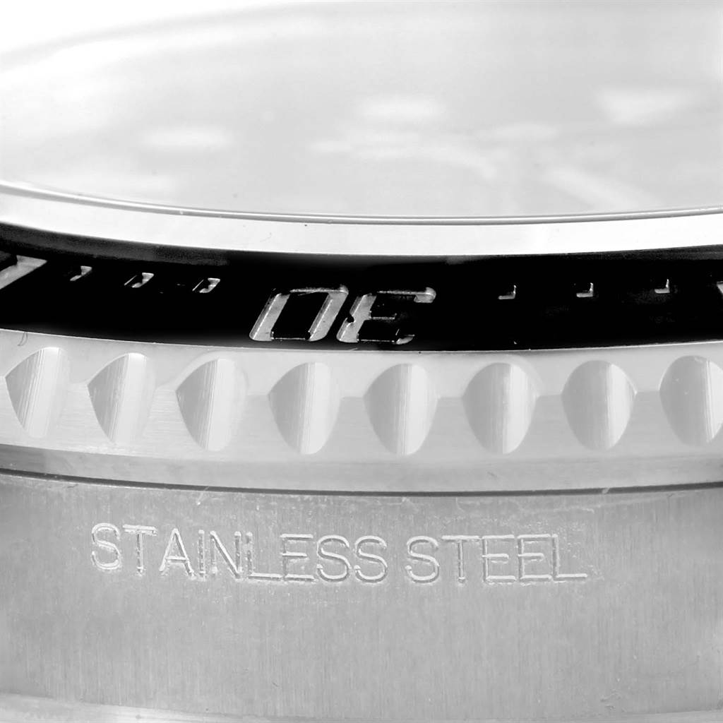 This image shows a close-up of the bezel, edge of the dial, and stainless steel case of a Rolex Sea-Dweller 116600 Men's Stainless Steel Black Dial 116600 Men's Stainless Steel Black Dial watch.