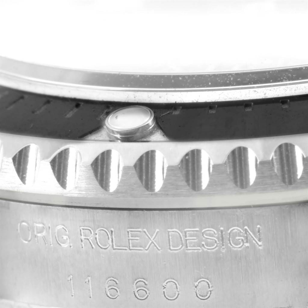 This close-up image of the Rolex Sea-Dweller 116600 Men's Stainless Steel Black Dial 116600 Men's Stainless Steel Black Dial watch shows the case's engraved model number 116600, part of the bezel, and casing.