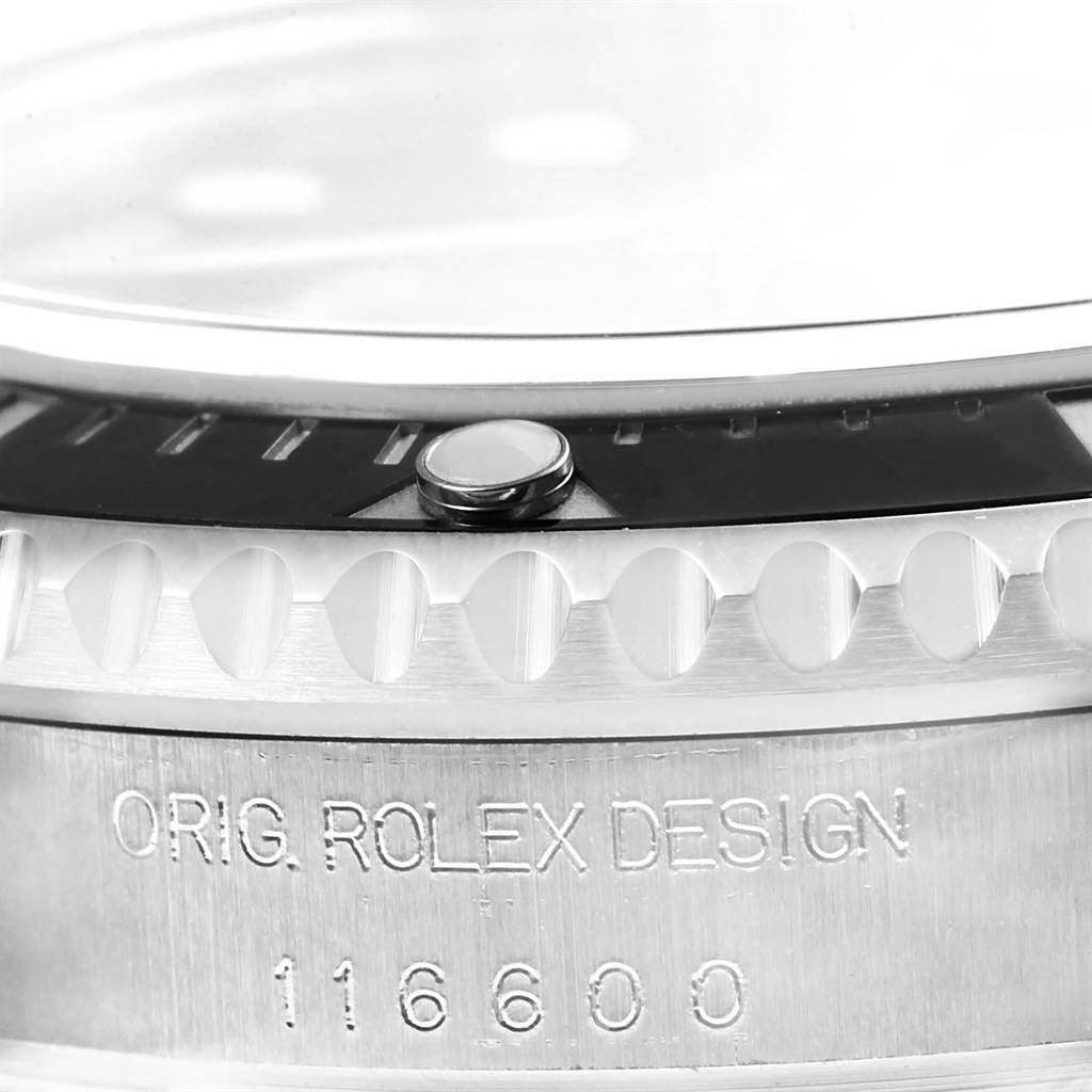 This close-up image shows the side view of the bezel and the engraved side of the case of a Rolex Sea-Dweller 116600 Men
s Stainless Steel Black Dial 116600 Men
s Stainless Steel Black Dial model.