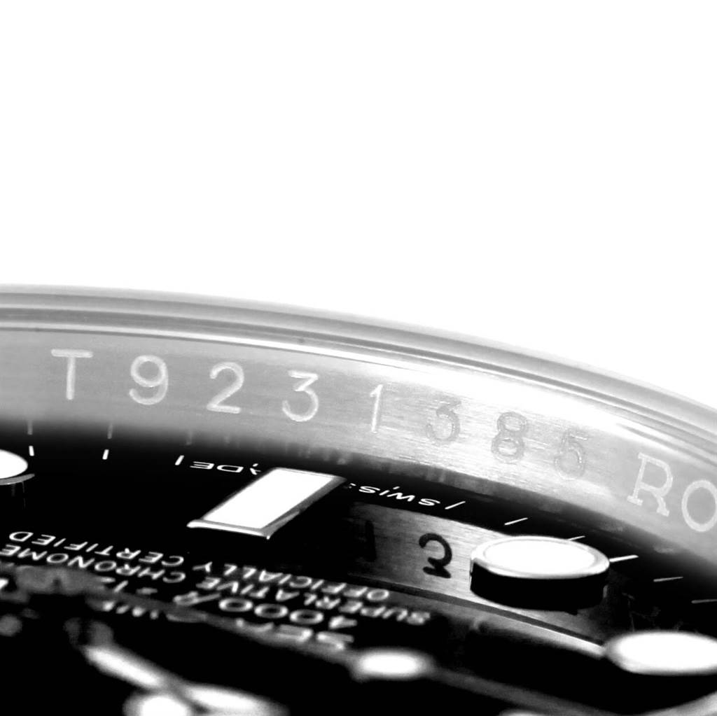 This close-up image of the Rolex Sea-Dweller 116600 Men
s Stainless Steel Black Dial 116600 Men
s Stainless Steel Black Dial watch shows part of the bezel, dial, and engraved serial number.