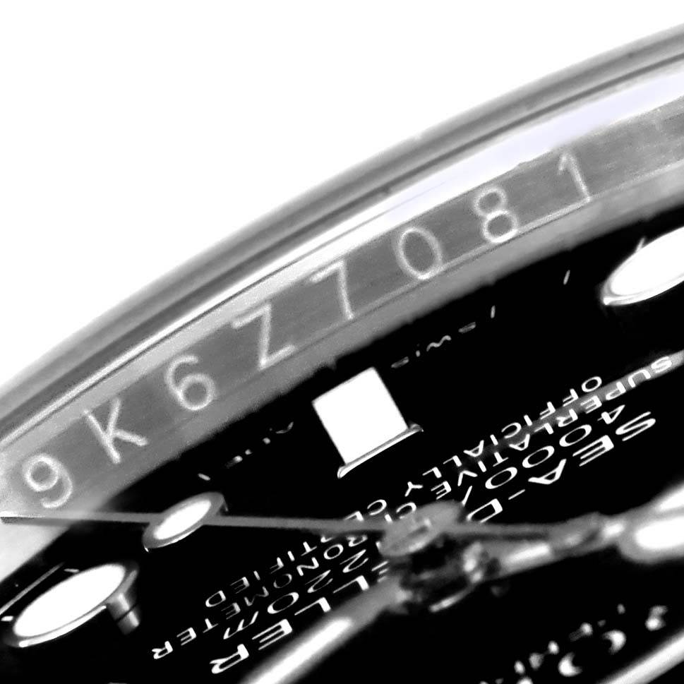 This close-up of the Rolex Sea-Dweller 116600 Men
s Stainless Steel Black Dial 116600 Men
s Stainless Steel Black Dial watch shows part of the dial and the serial number on the inner bezel.
