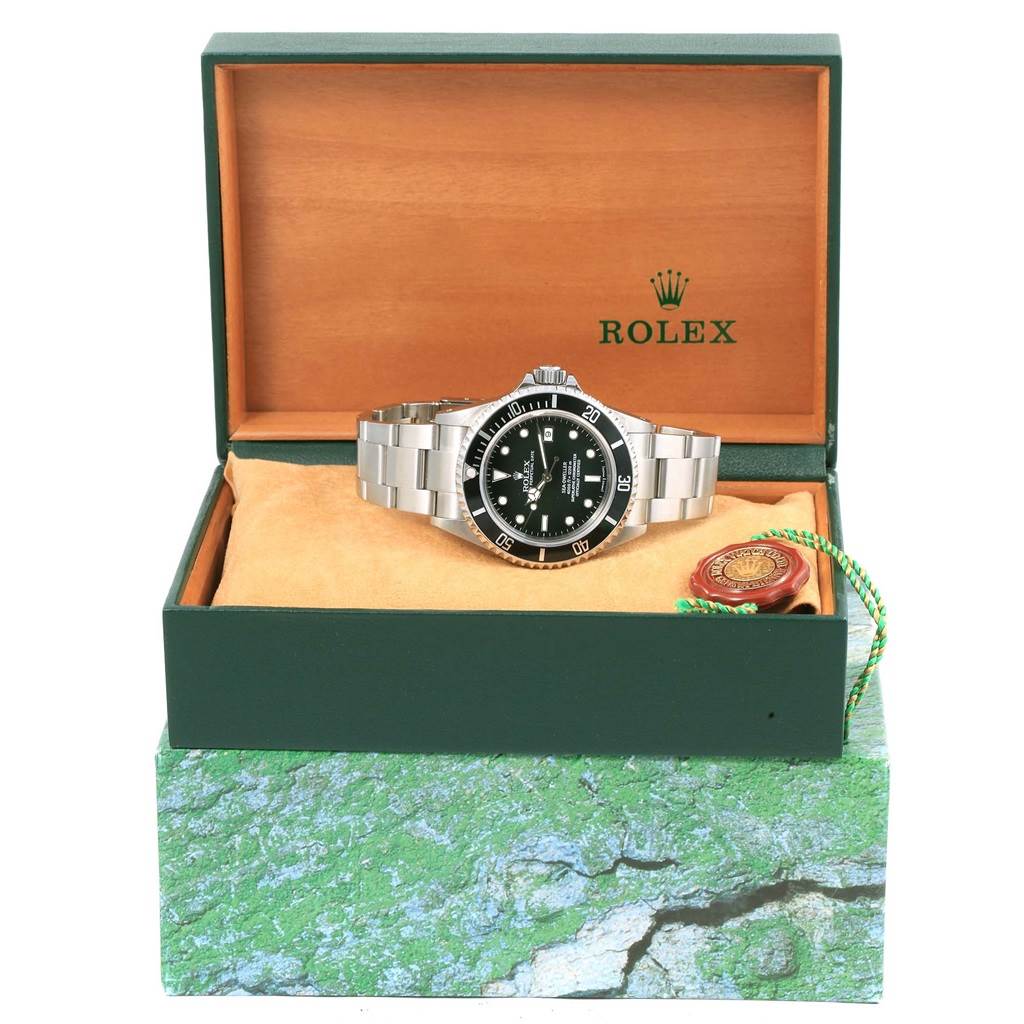 The Rolex Sea-Dweller 16600 Men
s Stainless Steel Black Dial 16600 Men
s Stainless Steel Black Dial watch is shown from a front angle inside its open box, displaying the face, bezel, and bracelet.