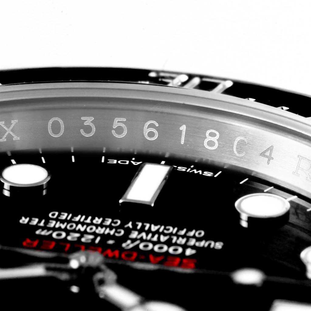The image shows a close-up of the Rolex Sea-Dweller 126600 Men
s Stainless Steel Black Dial 126600 Men
s Stainless Steel Black Dial watch face, focusing on the serial number on the inner bezel.