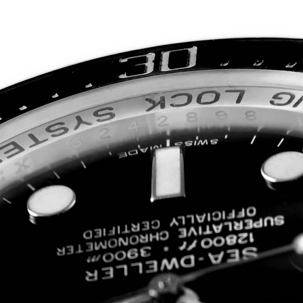 This close-up of the Rolex Sea-Dweller 116660 Men
s Stainless Steel Black Dial 116660 Men
s Stainless Steel Black Dial watch shows the dial, part of the bezel, and some text.