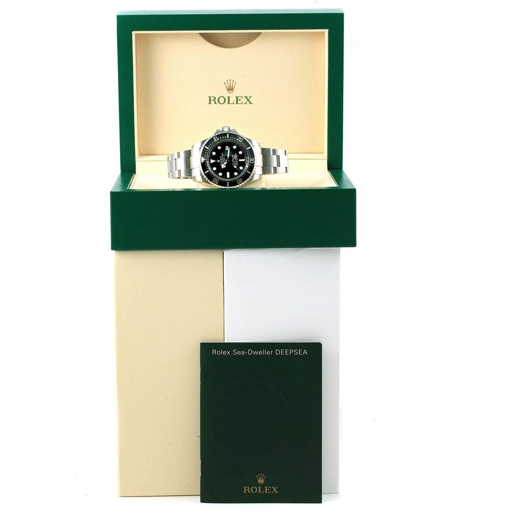 The Rolex Sea-Dweller 116660 Men's Stainless Steel Black Dial 116660 Men's Stainless Steel Black Dial watch is shown in its open box with the manual displayed in front.