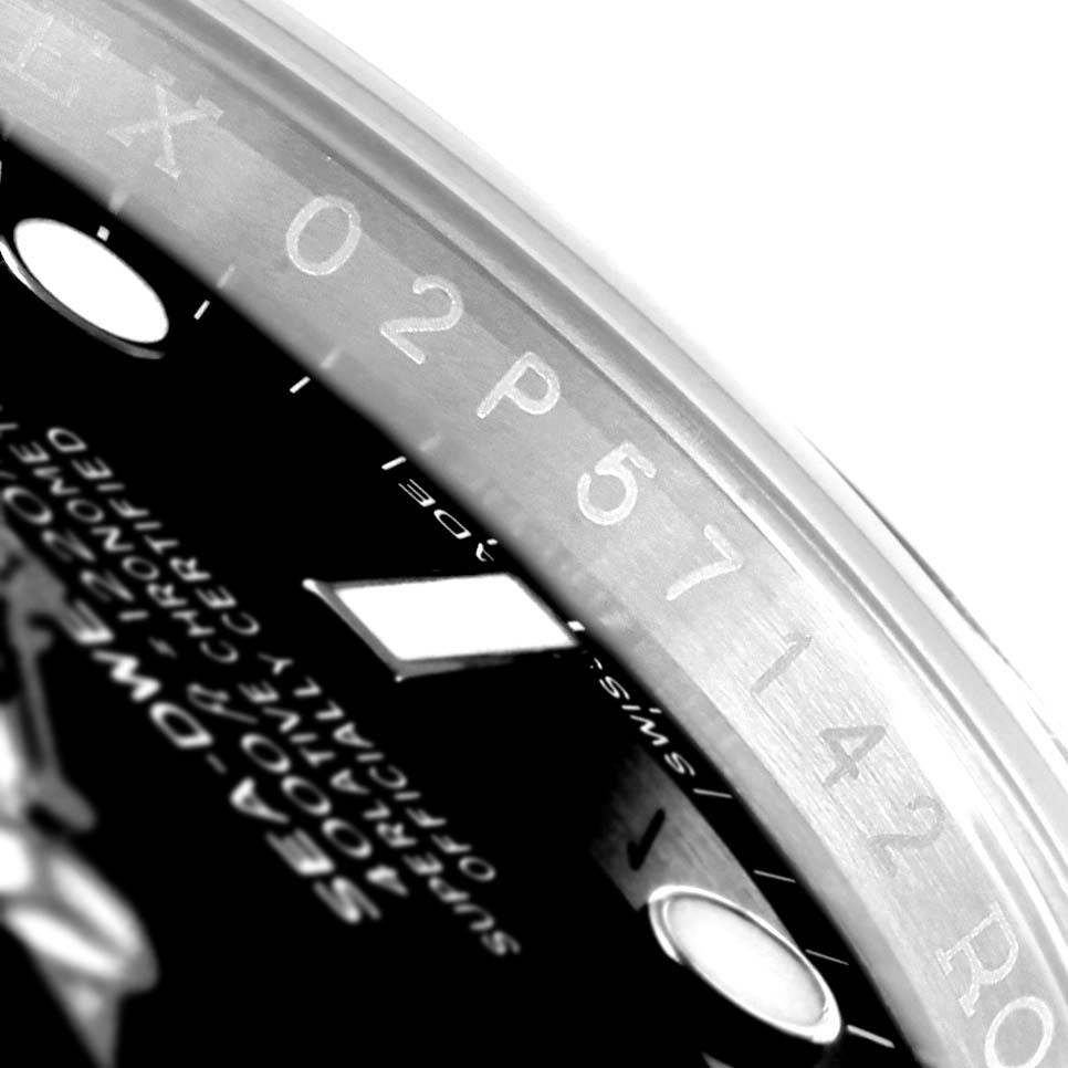 The image shows a close-up of the bezel and part of the dial of a Rolex Sea-Dweller 116600 Men
s Stainless Steel Black Dial 116600 Men
s Stainless Steel Black Dial watch, highlighting the serial number.