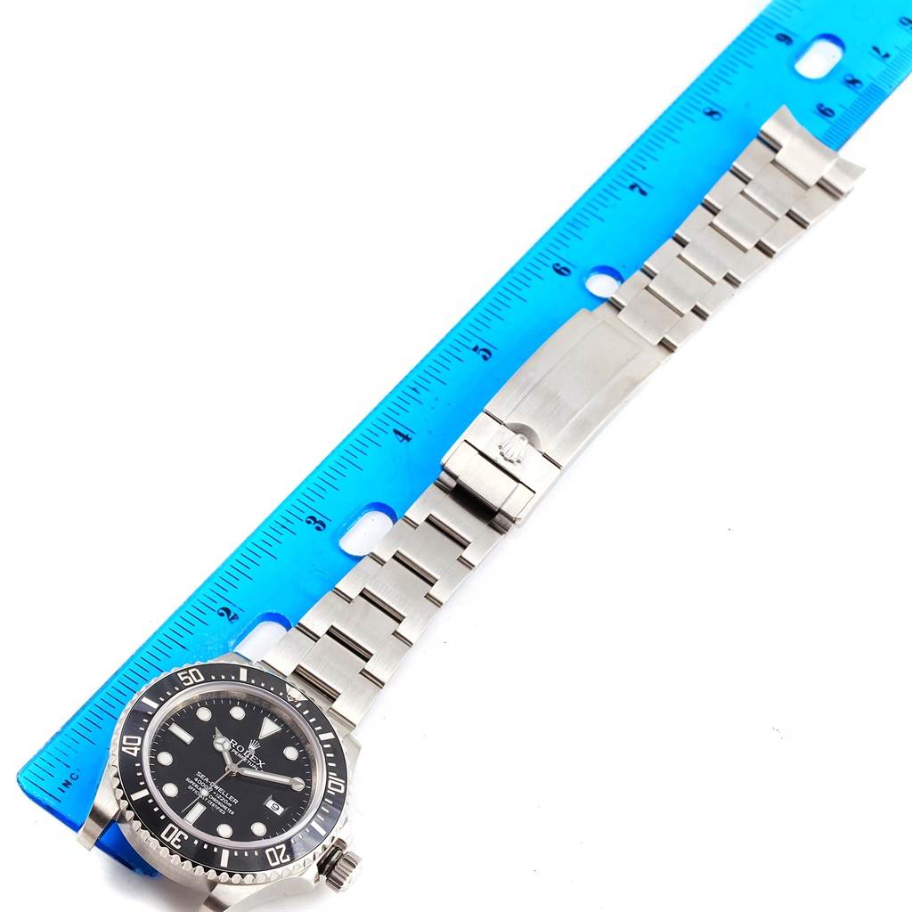 The image shows a Rolex Sea-Dweller 116600 Men's Stainless Steel Black Dial 116600 Men's Stainless Steel Black Dial watch, displaying the dial, the entire bracelet, and the clasp, alongside a blue ruler for scale.